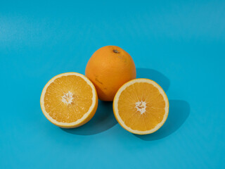 Ripe oranges on a blue background. Oranges on blue.