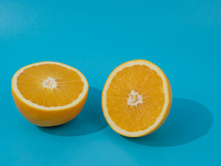 Ripe oranges on a blue background. Oranges on blue.