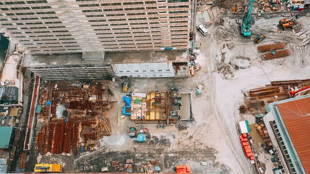excavator and other machinery with Workers are engaged in repairing development on construction site. timelapse time lapse flat view Construction And Development Of Modern Multi-storey Residential