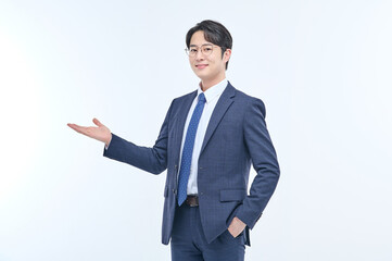 A young and handsome Asian man in a suit is wearing glasses and making various facial expressions and hand gestures.