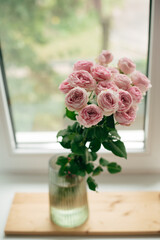 bouquet of pink roses on the window