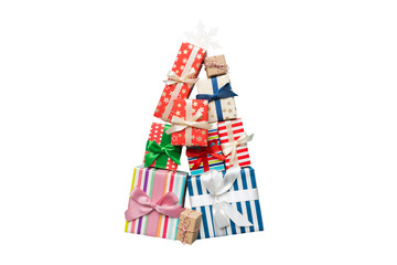 Obraz premium Isolated Christmas tree made of beautifuly wrapped presents on colored background, view from above. New Year gift box minimal concept