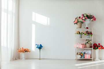 a shelf with flowers in a bright room for the holiday