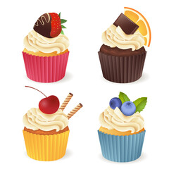 Set of cupcakes with different toppings isolated on white.