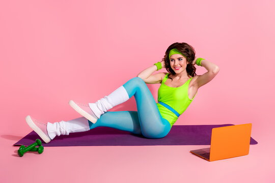Photo of coach sporty lady watch sport exercise video on youtube netbook practice in club isolated pastel color background