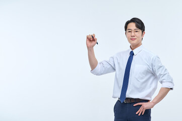 A young, handsome Asian man wearing glasses and a dress shirt and tie is holding a pen and explaining about business.