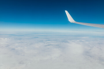 airplane wing in the sky with clouds travel flight