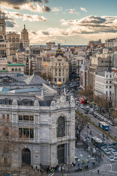 Madrid, Spain - January 26, 2018 : Madrid skyline sunset view, Metropolis, Banco de Espana (Central Bank buildings and Gran Via and Alcala street junction from Cibeles Palace Townhall