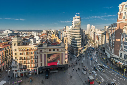 Madrid, Spain - January 15, 2018 : Morning aerial view of Plaza de Callao, Gran via and Jacometrezo street Junction. Plaza de Espana, Teatro Real and Royal Palace in the Back