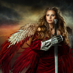 Warrior Woman with Sword. Medieval Female Knight in Armor. Beautiful Viking Girl as Battle Goddess with Wings in Red Fantasy Dress over Sky Background