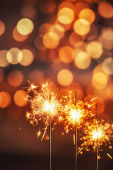 Sparklers over a dark background and bokeh lights, festive atmosphere