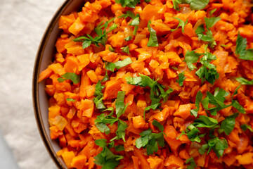 Homemade Smoky Spiced Carrot Rice with Parsley in a Bowl, top view. Close-up.
