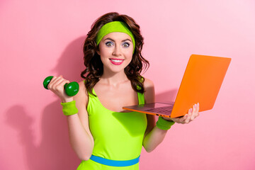 Photo of determined excited sporty woman coach lady watch video netbook with dumbbells isolated on...