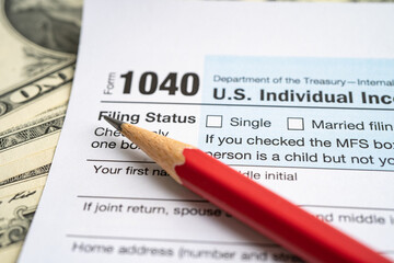 Tax Return form 1040 with USA America flag and dollar banknote, U.S. Individual Income.