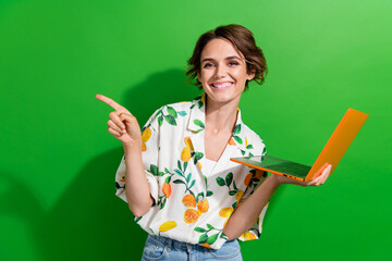 Photo of pretty adorable lady wear print shirt typing modern device pointing empty space isolated green color background