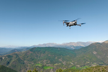 Fototapeta na wymiar Free flight of a UAS Drone in the background mountains