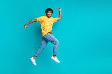 Fototapeta na wymiar Full size profile photo of energetic active guy jump rush empty space ad isolated on teal color background