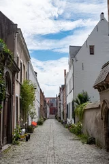Deurstickers This serene image captures an empty cobblestone street in Mechelen's Groot Begijnhof. The quiet laneway, lined with historic architecture, offers a glimpse into the medieval charm of this Flemish city © Bjorn B