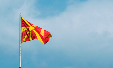 The national flag of North Macedonia waving in the wind in Skopje