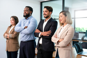 portrait four multiracial business people standing arm cross in the office, concept of business,office employee