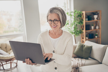 Photo of shiny smiling elderly lady wear white cardigan communicating instagram twitter telegram...