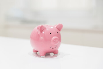 Piggy bank placed on white plain table indoors