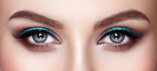 Obraz premium Beautiful female eyes with long eyelashes. Eyelash extensions. Makeup, cosmetics, beauty. Close up, macro
