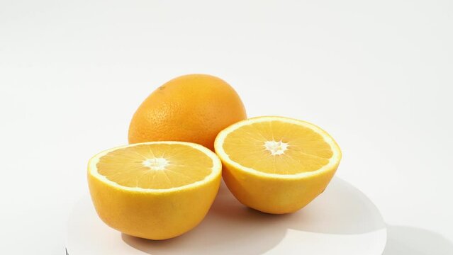 Ripe oranges rotate on a white background. Oranges close-up on white.