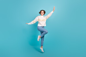 Full body photo of young woman bob brown hair jump air trampoline flying hands wings autumn clothes isolated on blue color background