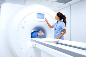 MRI technician radiologist preparing patient for full body examination in hospital diagnostic...