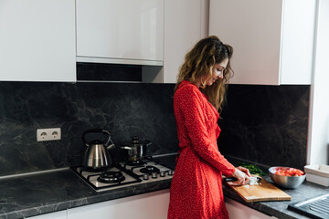 Beautiful woman preparing food in the kitchen