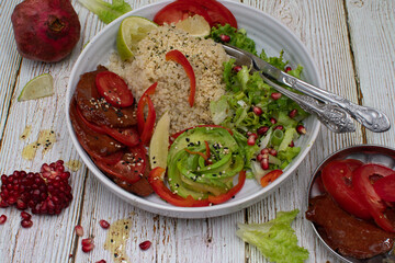 Vegan bowl consisting of seitan slices, quinoa, avocado and salad.  Copy space.