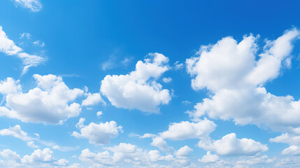 Naklejka na ściany i meble White clouds drifting in a clear blue sky.