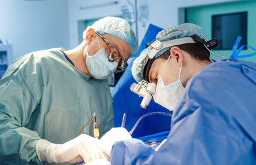 Neurosurgery specialists working in team. Emergency professional operating room.