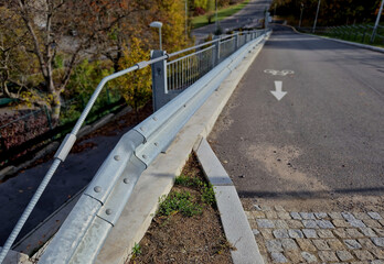 Reinforcement of the edge of the road with a concrete wall on which there are road barriers and...