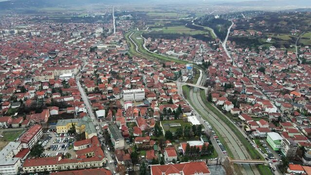 A river flows through the town Leskovac in hilly region of Serbia