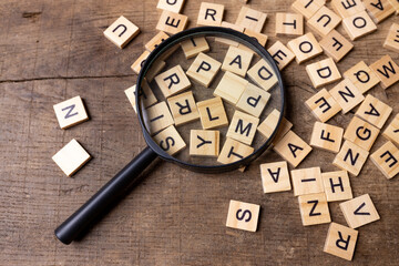 Magnifying glass with many wood letters of English alphabets, learning English concept