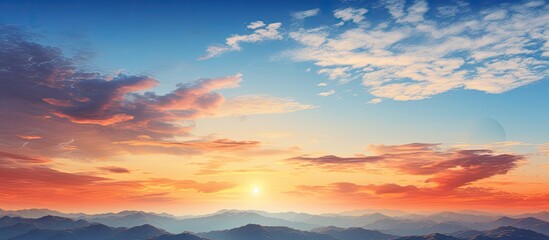 Fototapeta premium In the summer while traveling I admired the breathtaking landscape of mountains against the backdrop of a stunning blue sky filled with fluffy white clouds as the golden sun slowly melted in