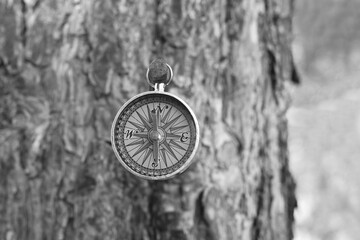 black and white photo of round compass