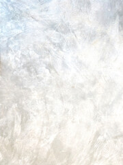 The light-colored cement wall has cracks.