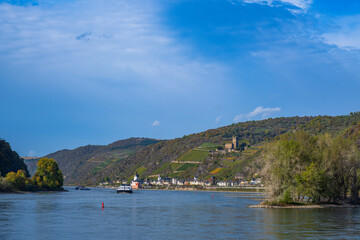 Fototapeta na wymiar View over the Rhine on a sunny autumn day near Kaub/Germany with inland waterway vessels