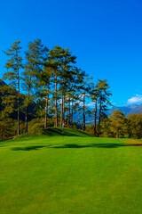 Fototapeta na wymiar Putting Green on Golf Course Menaggio with Mountain View in Autumn in Lombardy, Italy.