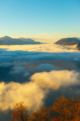 Fototapeta premium Mountain Peak Above Cloudscape with Sunlight and Clear Sky in Lugano, Ticino in Switzerland.