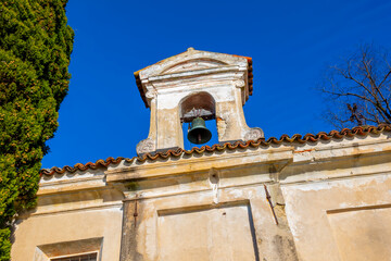 Church with Bell and a tree with Clear Blue Sky in Park San Michele in Castagnola in Lugano, Ticino...