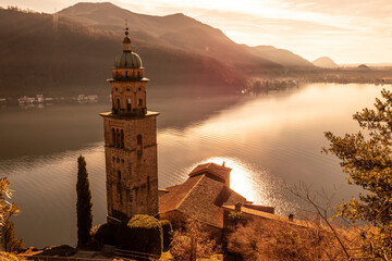 Church Tower Santa Maria del Sasso with Sunlight and Mountain on Lake Lugano in Morcote, Ticino in...