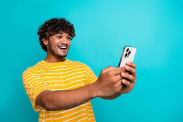 Photo of handsome guy device instagram twitter facebook telegram dressed stylish striped yellow outfit isolated on cyan color background - 676415300