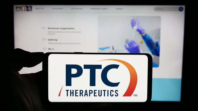 Stuttgart, Germany - 11-07-2023: Person holding mobile phone with logo of American pharmaceutical company PTC Therapeutics Inc. in front of web page. Focus on phone display.