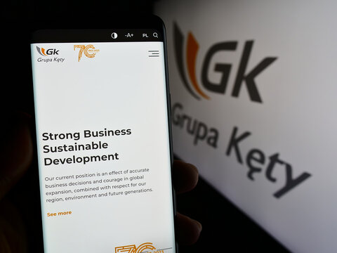Stuttgart, Germany - 11-07-2023: Person holding cellphone with webpage of Polish aluminium company Grupa Kety S.A. in front of business logo. Focus on center of phone display.