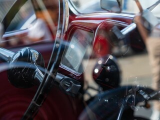 Interior of an old car as seen through a closed window