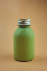 Healthy smoothies with fresh avocado milk and honey in bottle with silver color lid